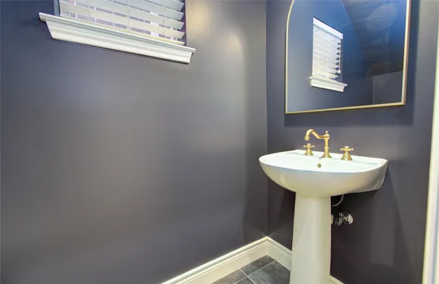 a bathroom with a tub shower and sink