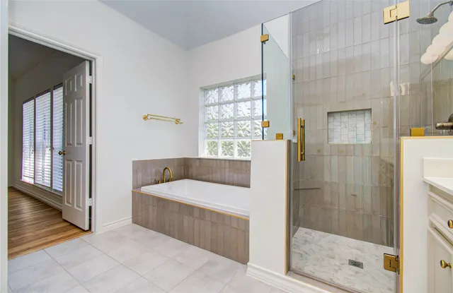 a view of empty room with wooden floor and vanity