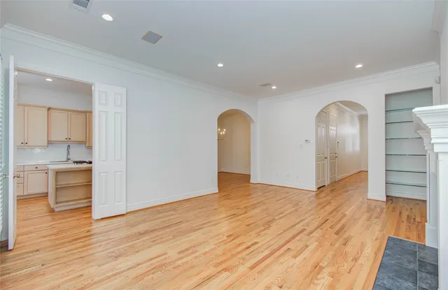 a kitchen with white cabinets and sink