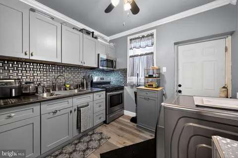a kitchen with a sink cabinets and window