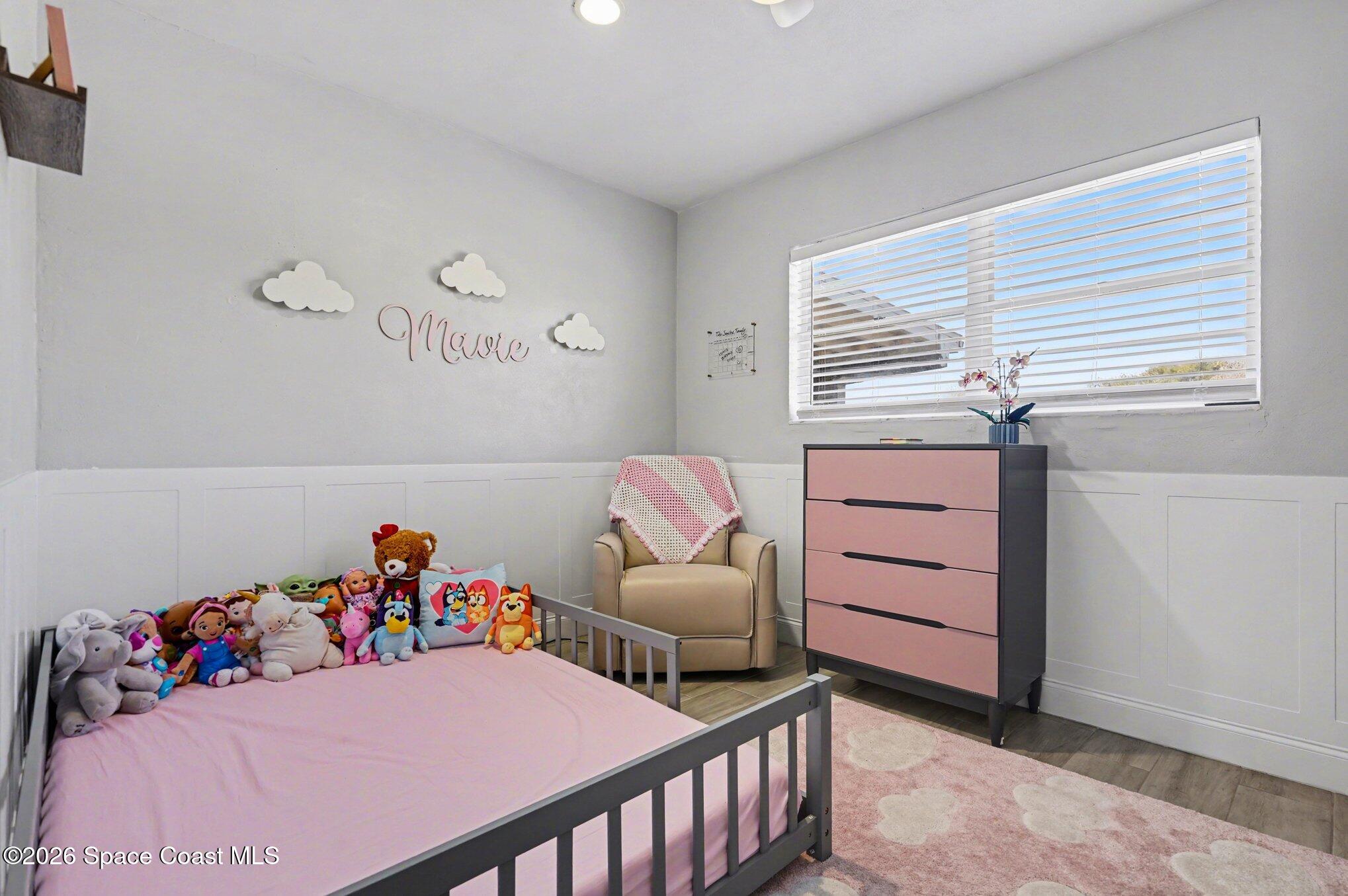 809 Espanola Way Melbourne, FL 32901 - Photo 16 of 27 a bedroom with furniture and a chair