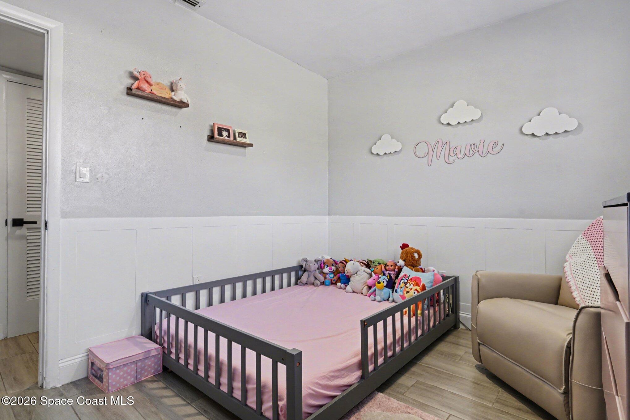 809 Espanola Way Melbourne, FL 32901 - Photo 17 of 27 a bedroom with furniture and a bed