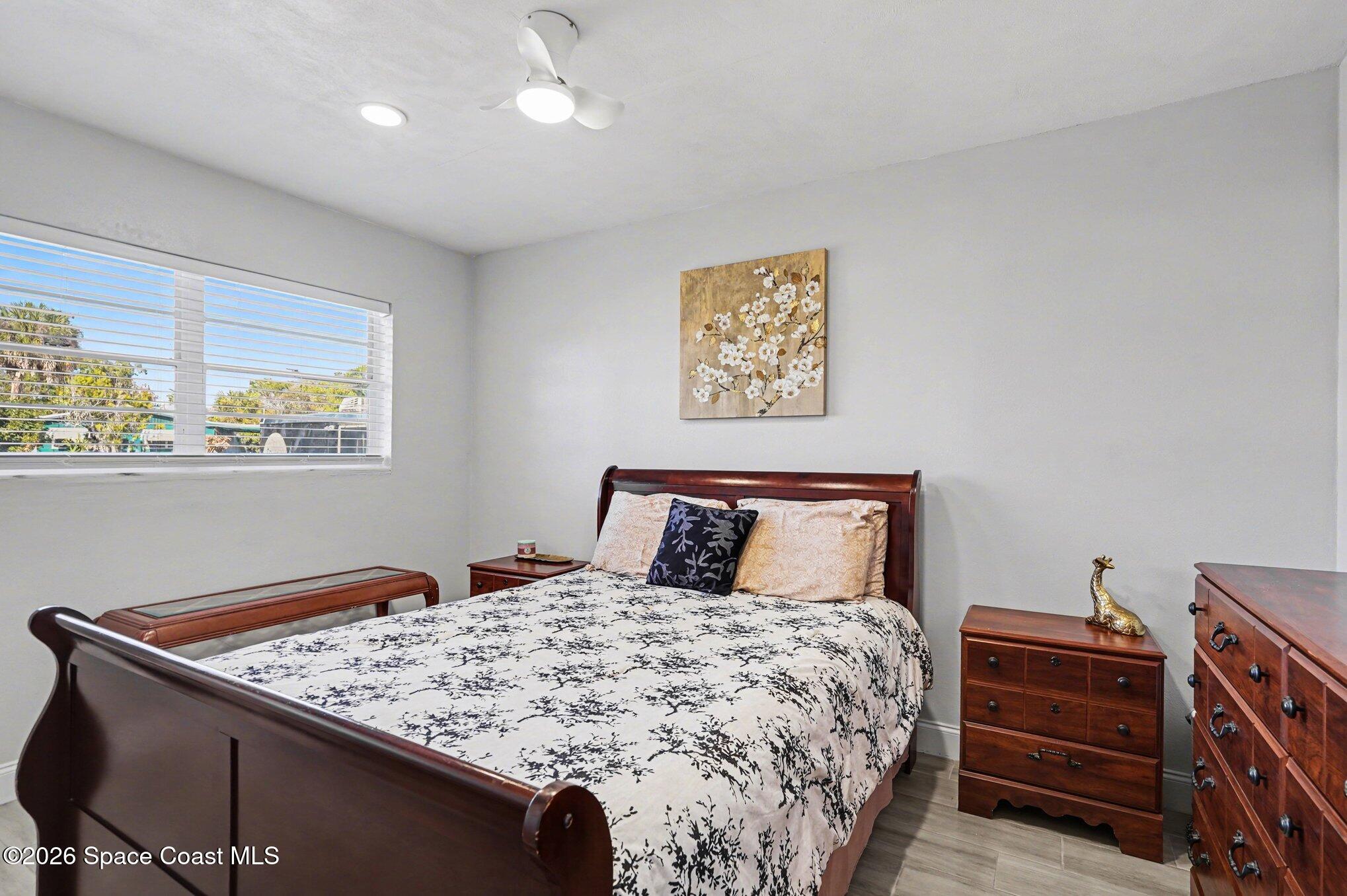 809 Espanola Way Melbourne, FL 32901 - Photo 18 of 27 a bed sitting in a bedroom next to a window