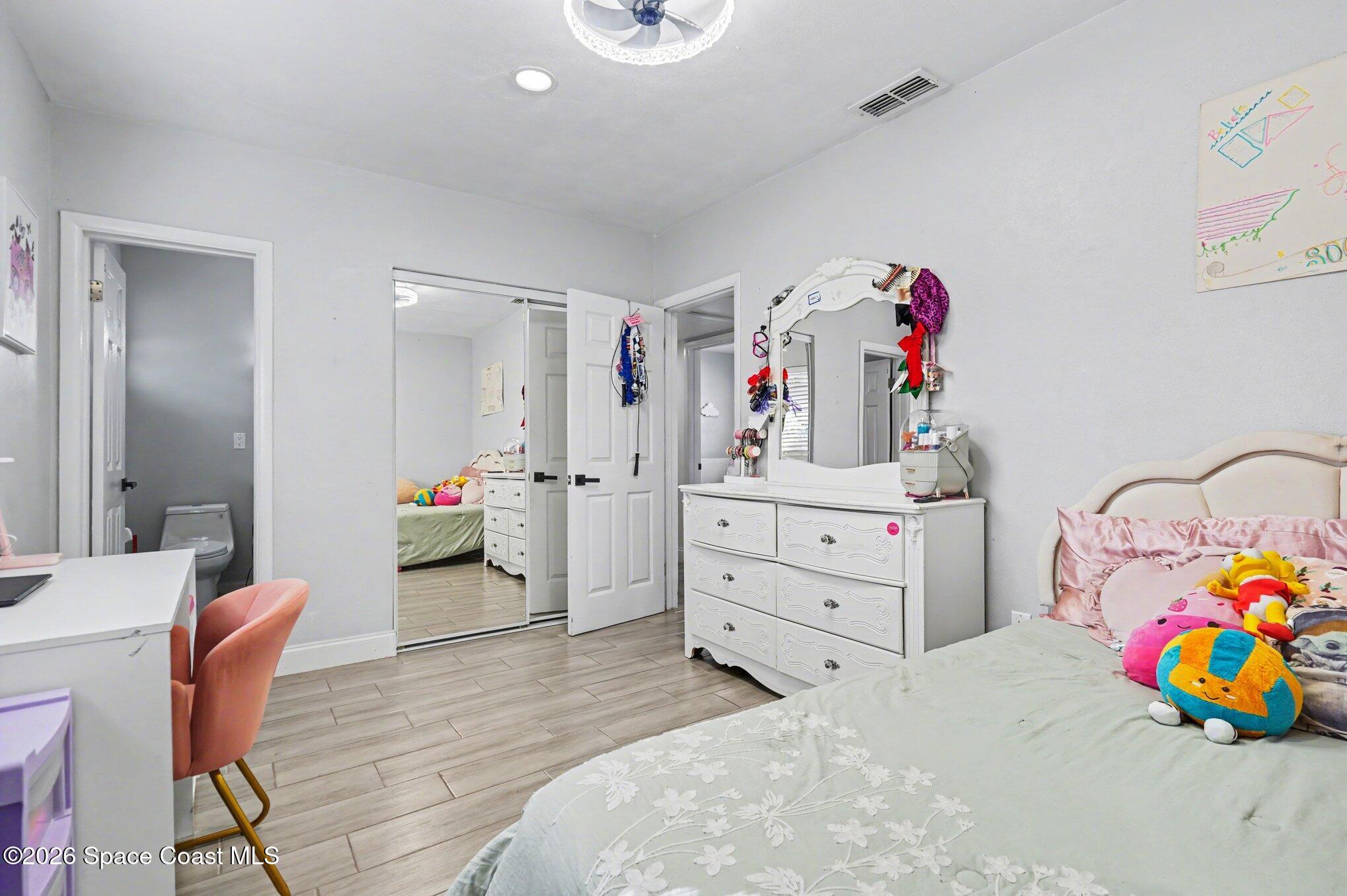 809 Espanola Way Melbourne, FL 32901 - Photo 21 of 27 a bedroom with a bed and furniture