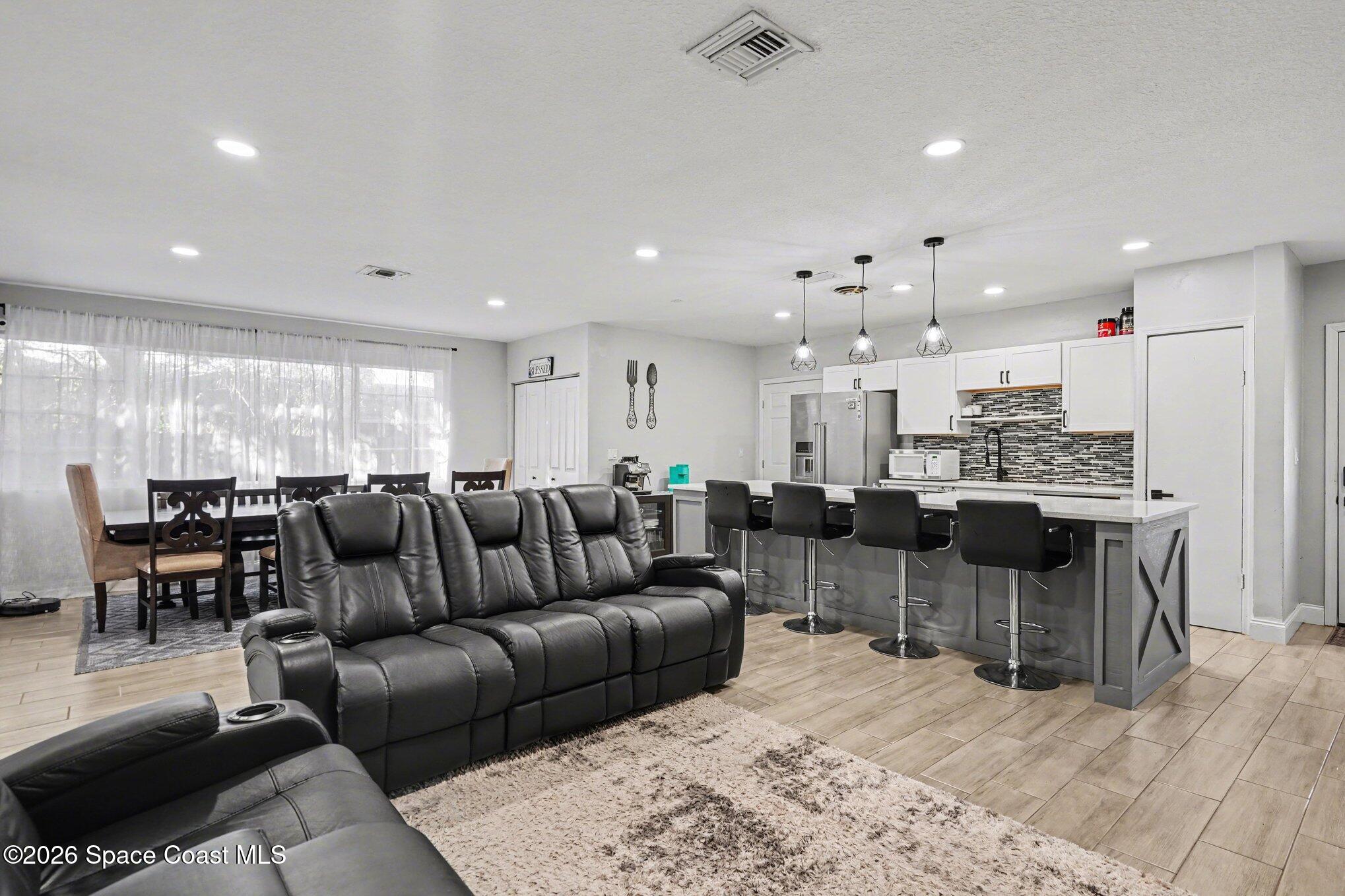 809 Espanola Way Melbourne, FL 32901 - Photo 4 of 27 a view of a living room kitchen and a kitchen island