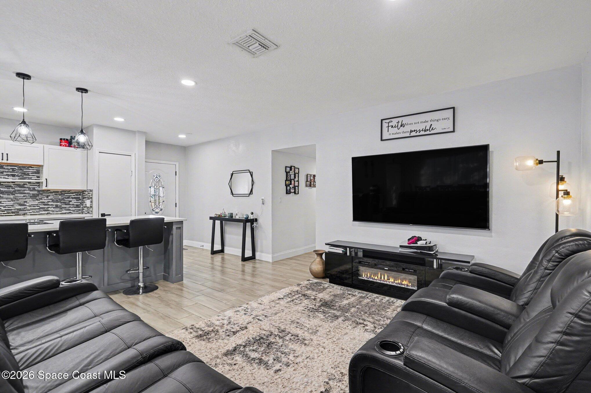 809 Espanola Way Melbourne, FL 32901 - Photo 7 of 27 a living room with furniture and a flat screen tv