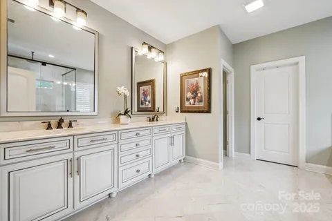 a spacious bathroom with a granite countertop sink mirror and