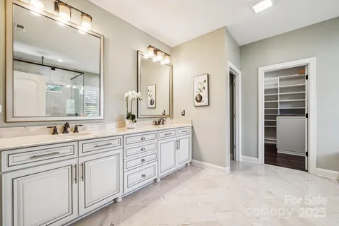 a spacious bathroom with a granite countertop sink mirror and