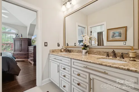 a bathroom with double sink and a mirror