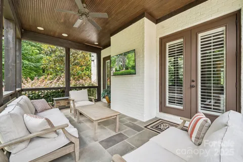a living room with furniture and large windows