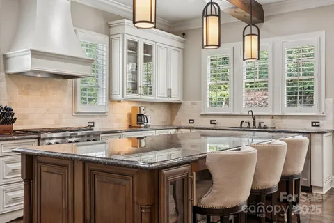 a kitchen with granite countertop a sink and a stove