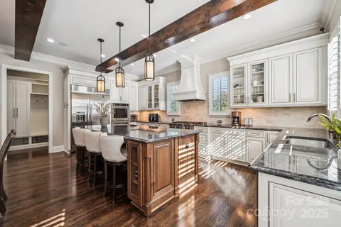 a kitchen with stainless steel appliances granite countertop a sink and cabinets