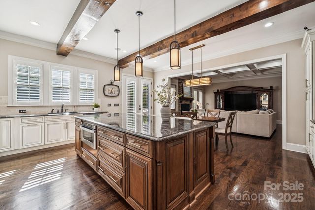 a kitchen with stainless steel appliances granite countertop a sink and stove