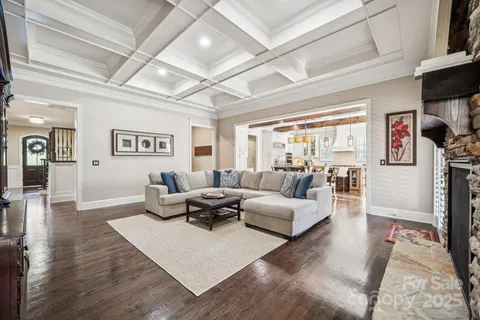 a living room with furniture wooden floor and a large window