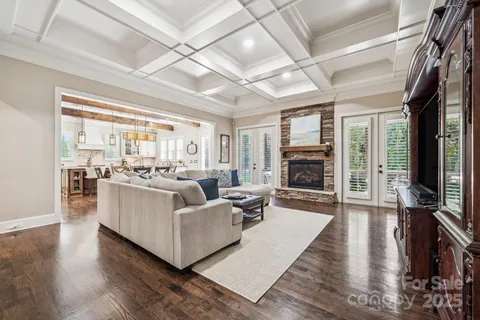 a living room with furniture wooden floor and a fireplace