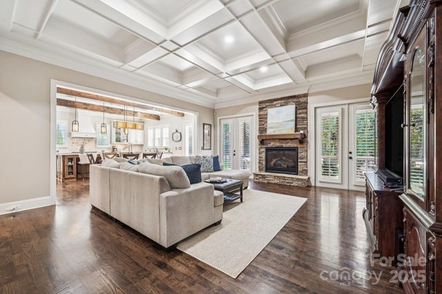 a living room with furniture wooden floor and a fireplace