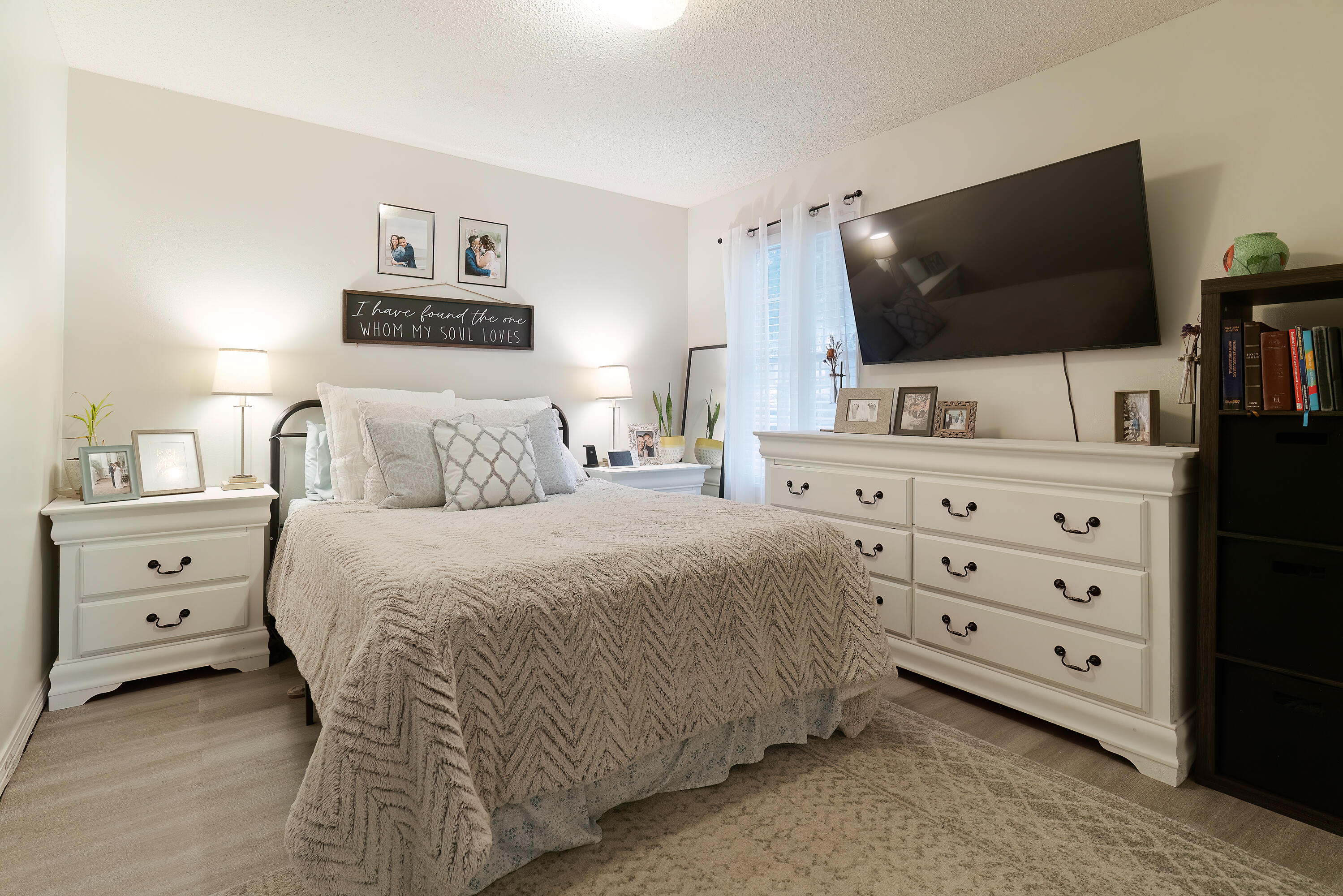 406 Cooper Street Crestview, FL 32539 - Photo 16 of 32 a bedroom with a bed and a flat screen tv in it