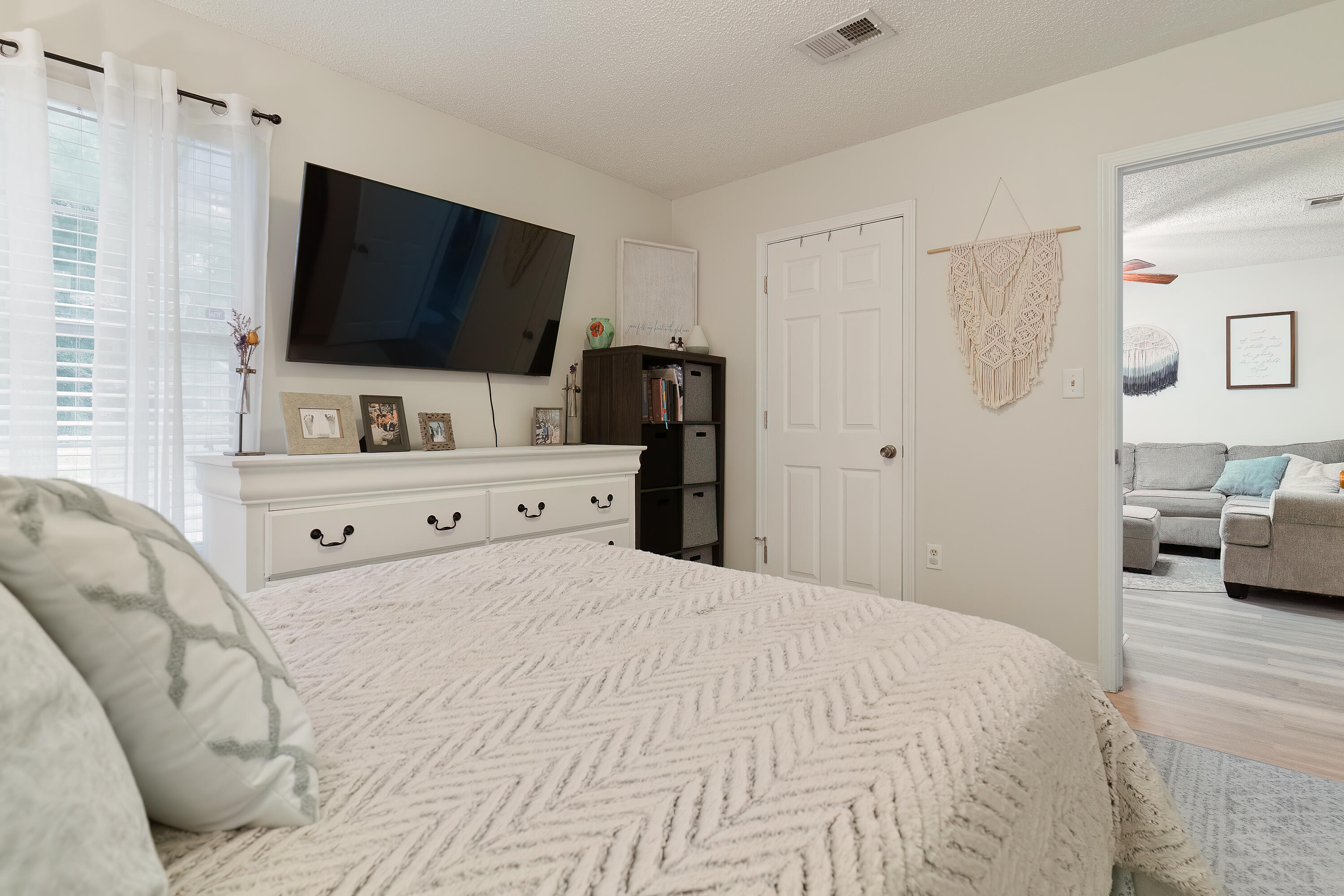 406 Cooper Street Crestview, FL 32539 - Photo 17 of 32 a bedroom with a bed and a flat screen tv