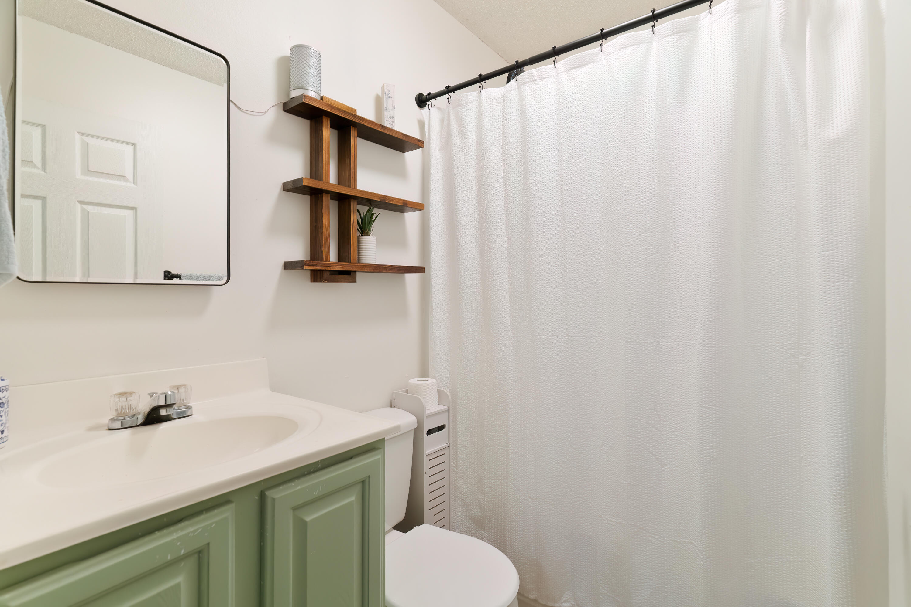 406 Cooper Street Crestview, FL 32539 - Photo 18 of 32 a bathroom with a sink and a mirror