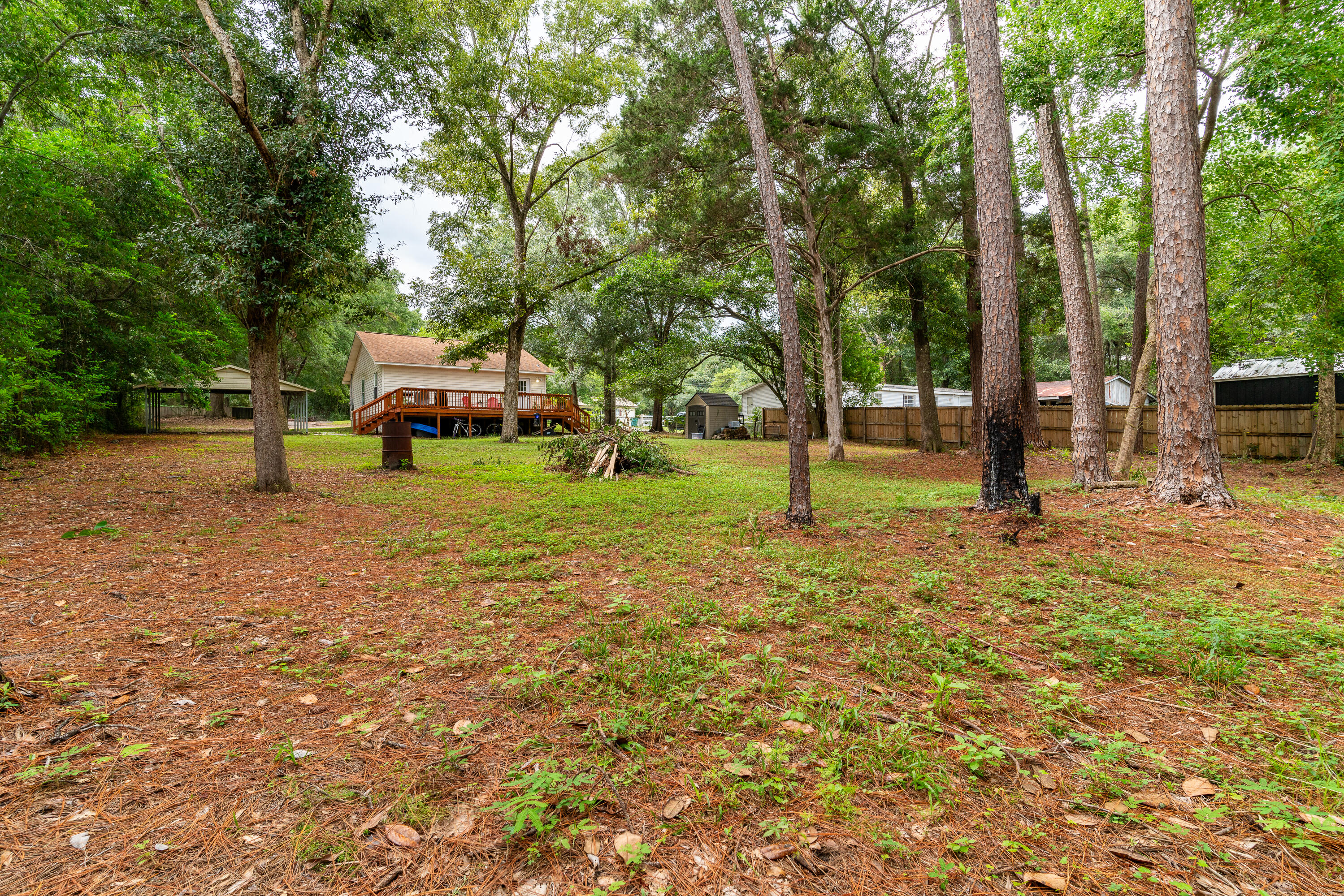 406 Cooper Street Crestview, FL 32539 - Photo 27 of 32 a view of a park with swings and a trees