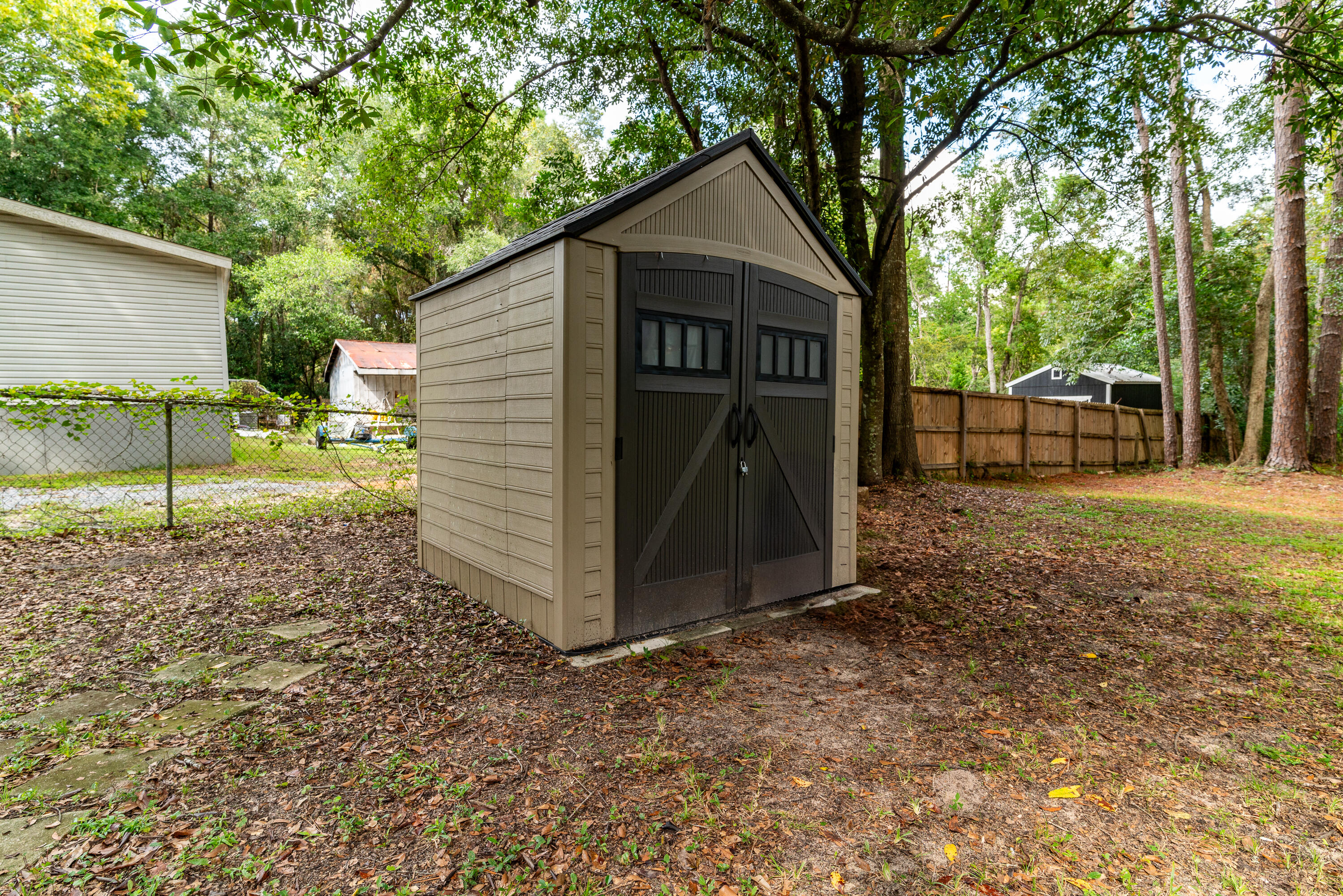 406 Cooper Street Crestview, FL 32539 - Photo 31 of 32 a view of a house with a yard and fence