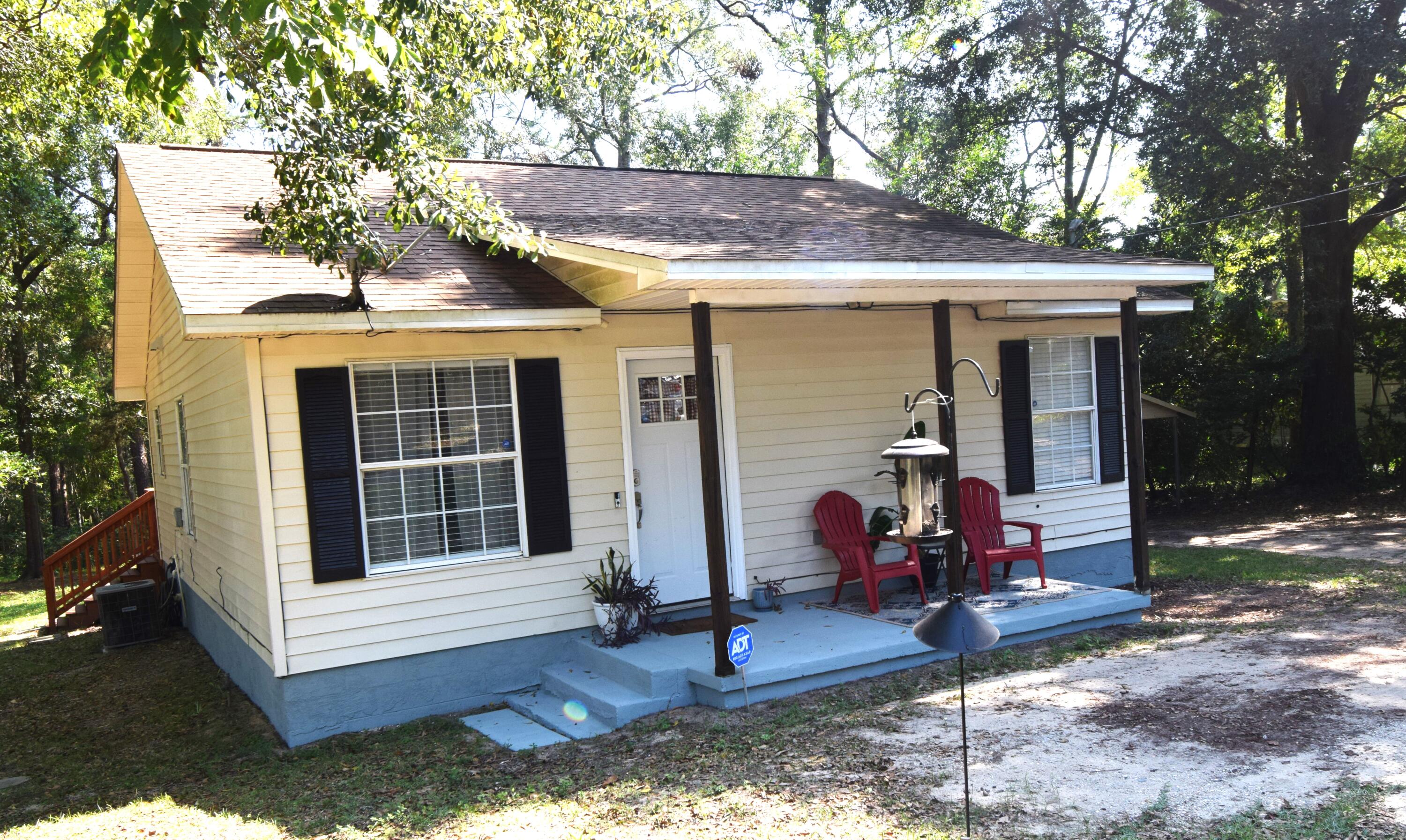 406 Cooper Street Crestview, FL 32539 - Photo 4 of 32 a view of a house with backyard porch and sitting area