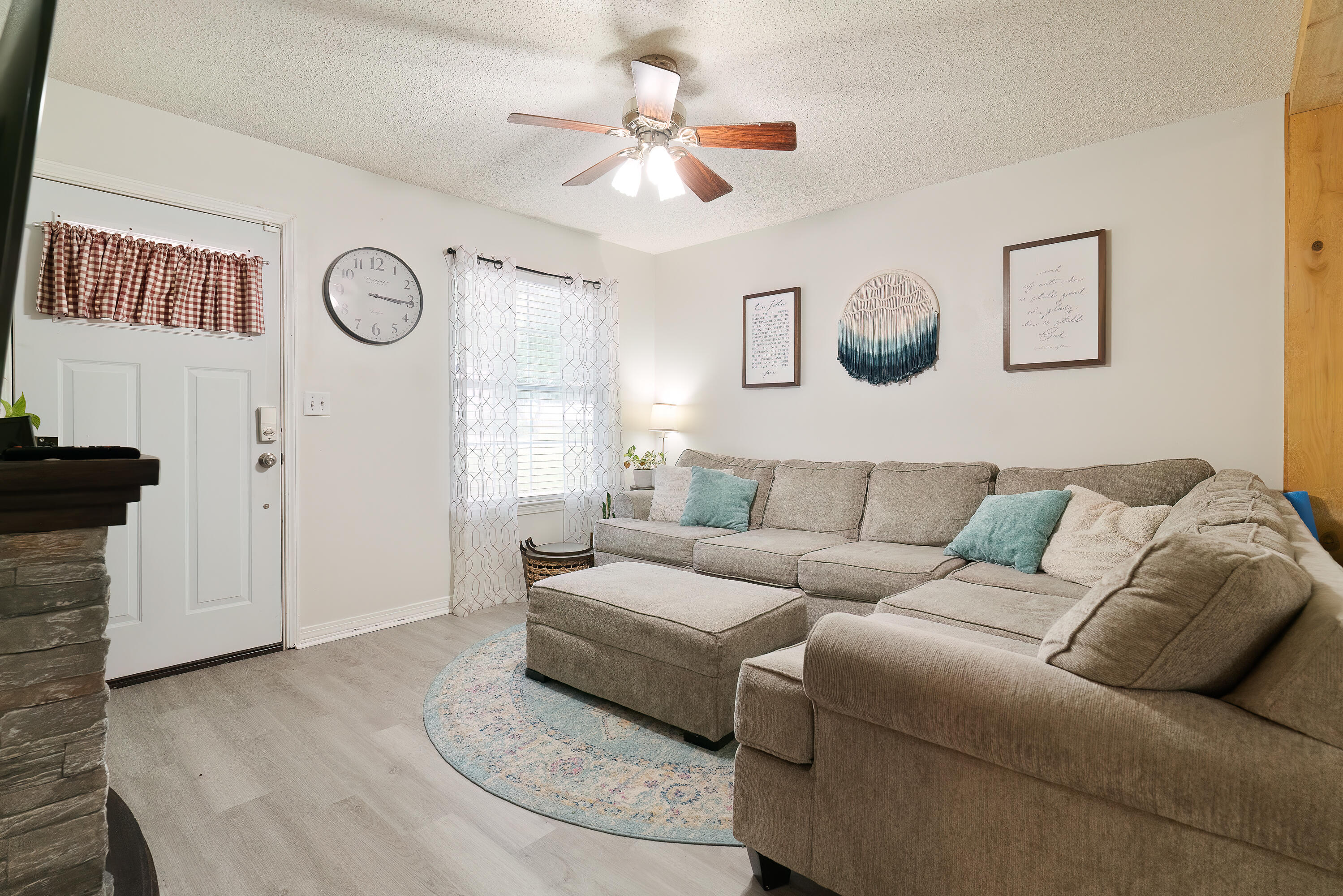 406 Cooper Street Crestview, FL 32539 - Photo 6 of 32 a living room with furniture a clock on wall and a window