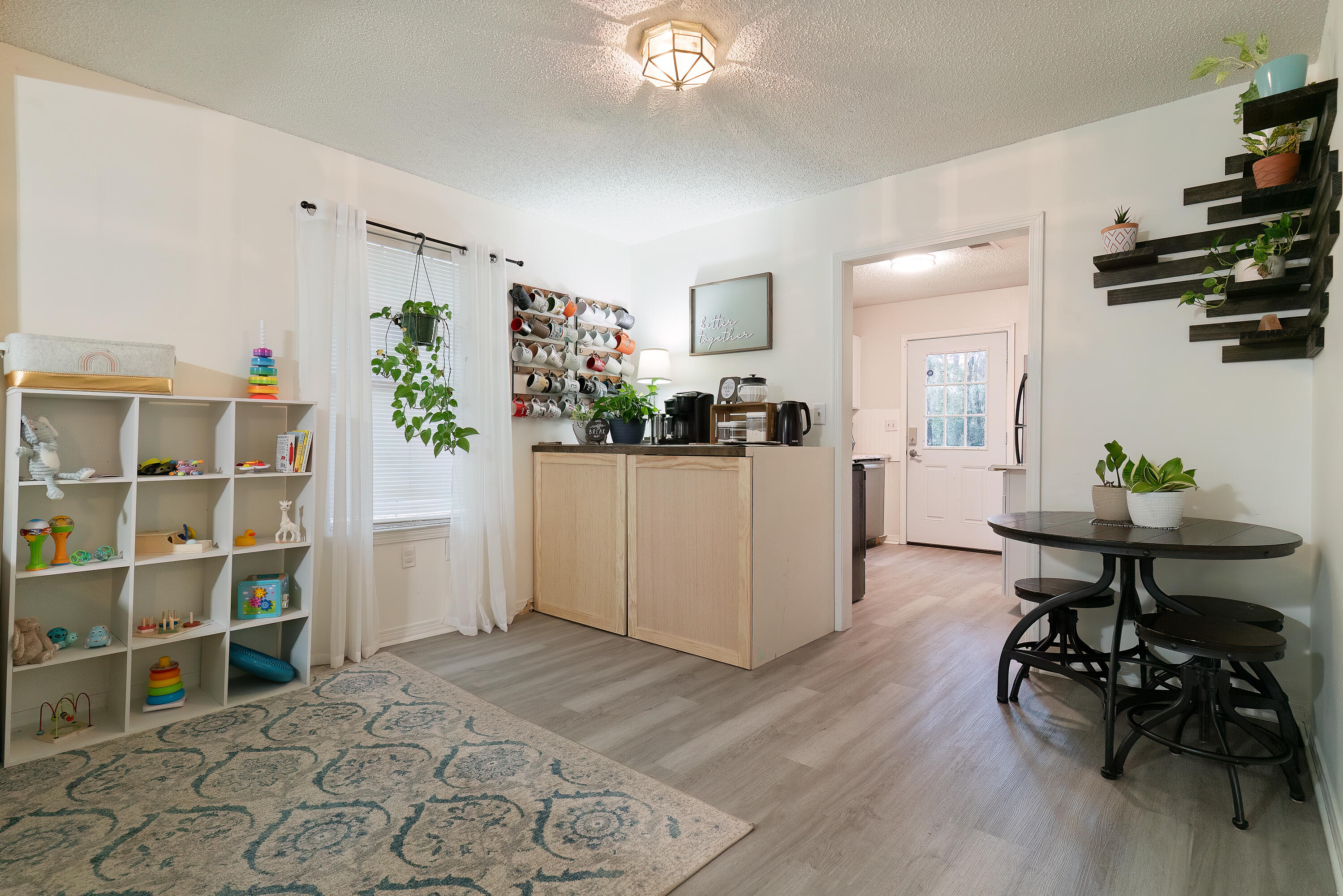 406 Cooper Street Crestview, FL 32539 - Photo 9 of 32 a view of a workspace with furniture and a kitchen
