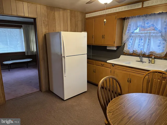 a kitchen with a refrigerator and a more cabinets