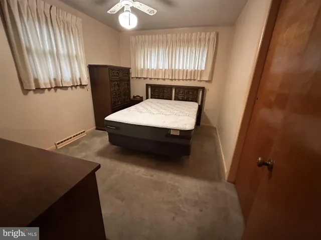 a bedroom with a bed and a mirror
