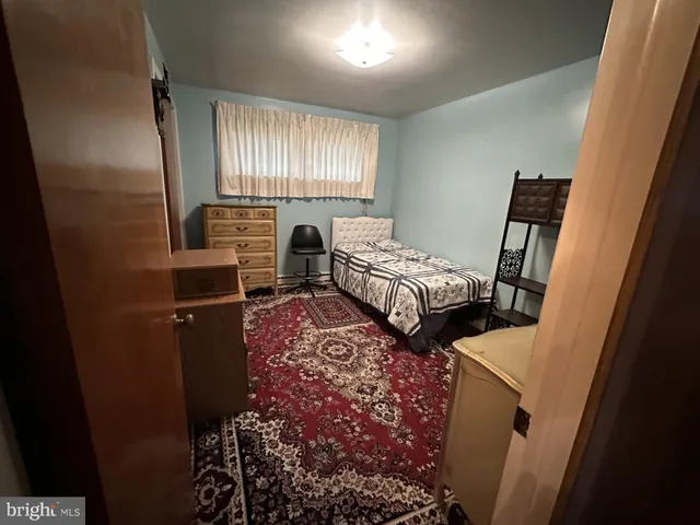 a bedroom with furniture and a window