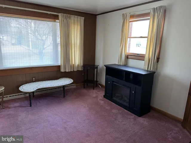 a living room with furniture and a bathtub