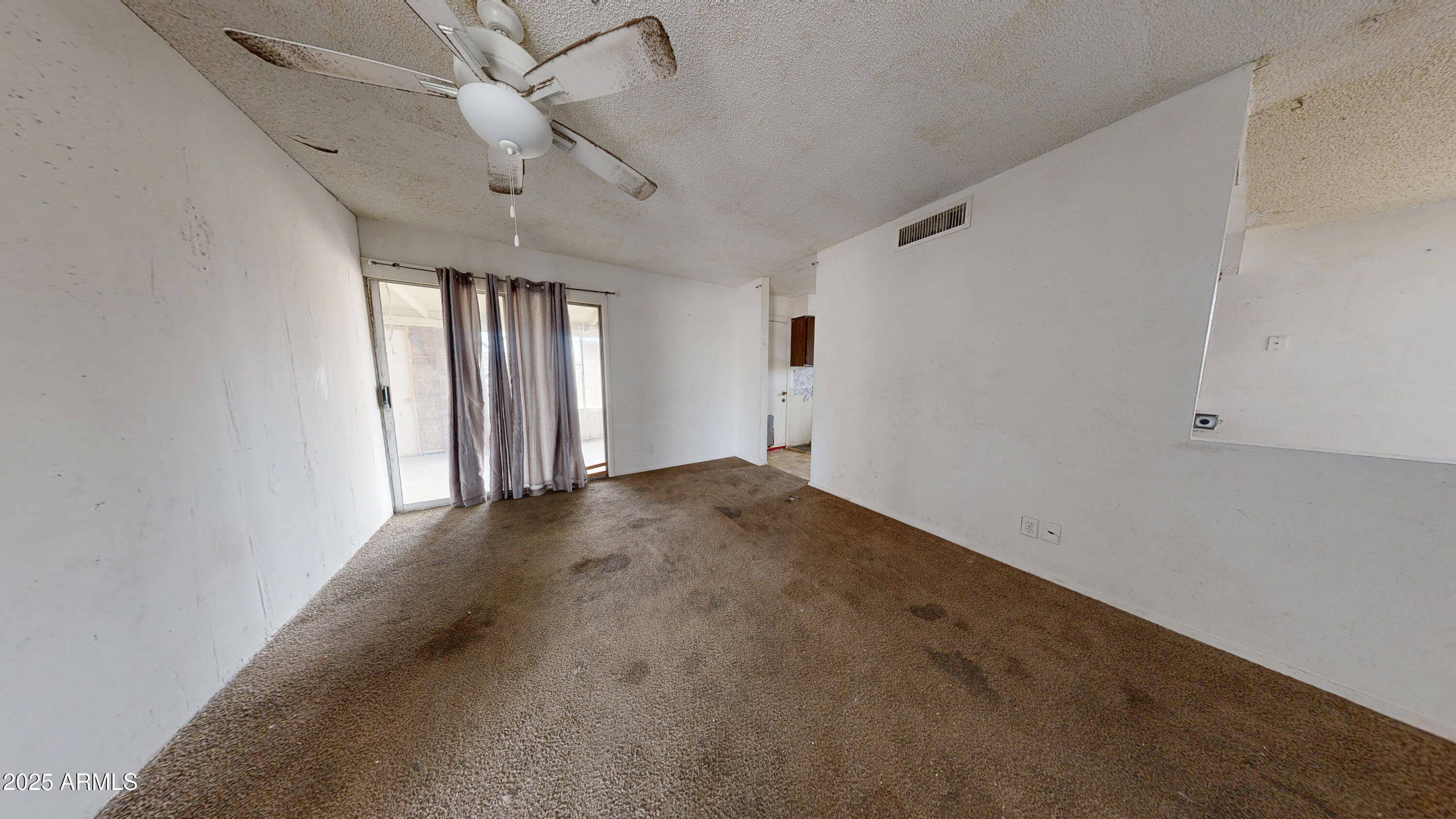 2351 South Royal Palm Road Apache Junction, AZ 85119 - Photo 2 of 21 en empty room with windows and ceiling fan