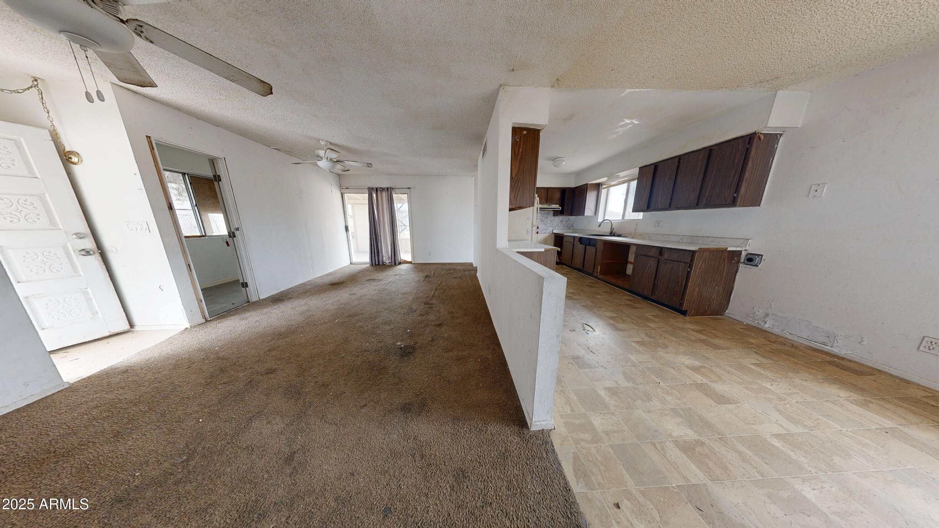 2351 South Royal Palm Road Apache Junction, AZ 85119 - Photo 4 of 21 a view of a kitchen with a sink and a refrigerator