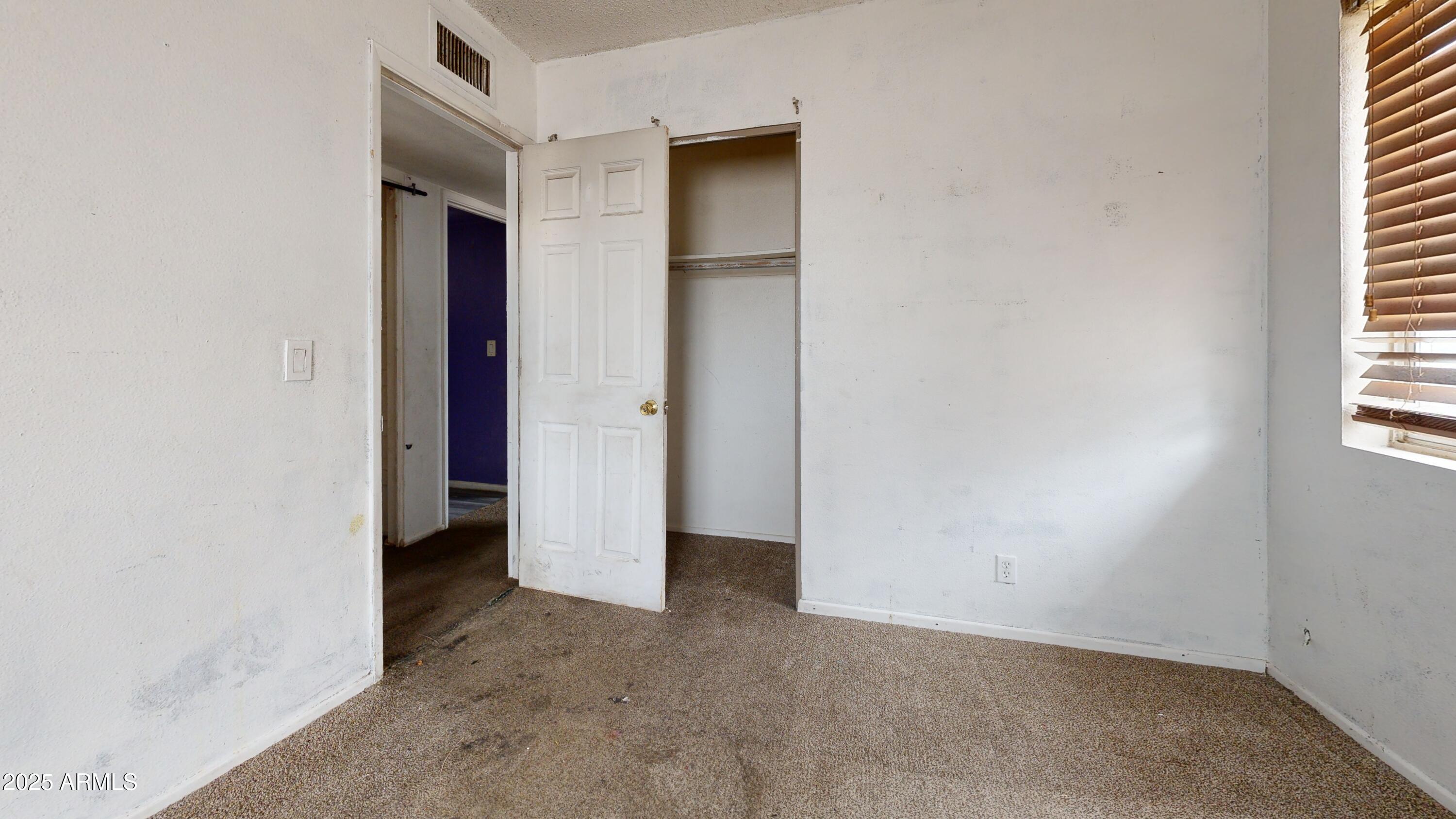 2351 South Royal Palm Road Apache Junction, AZ 85119 - Photo 7 of 21 an empty room with windows and closet
