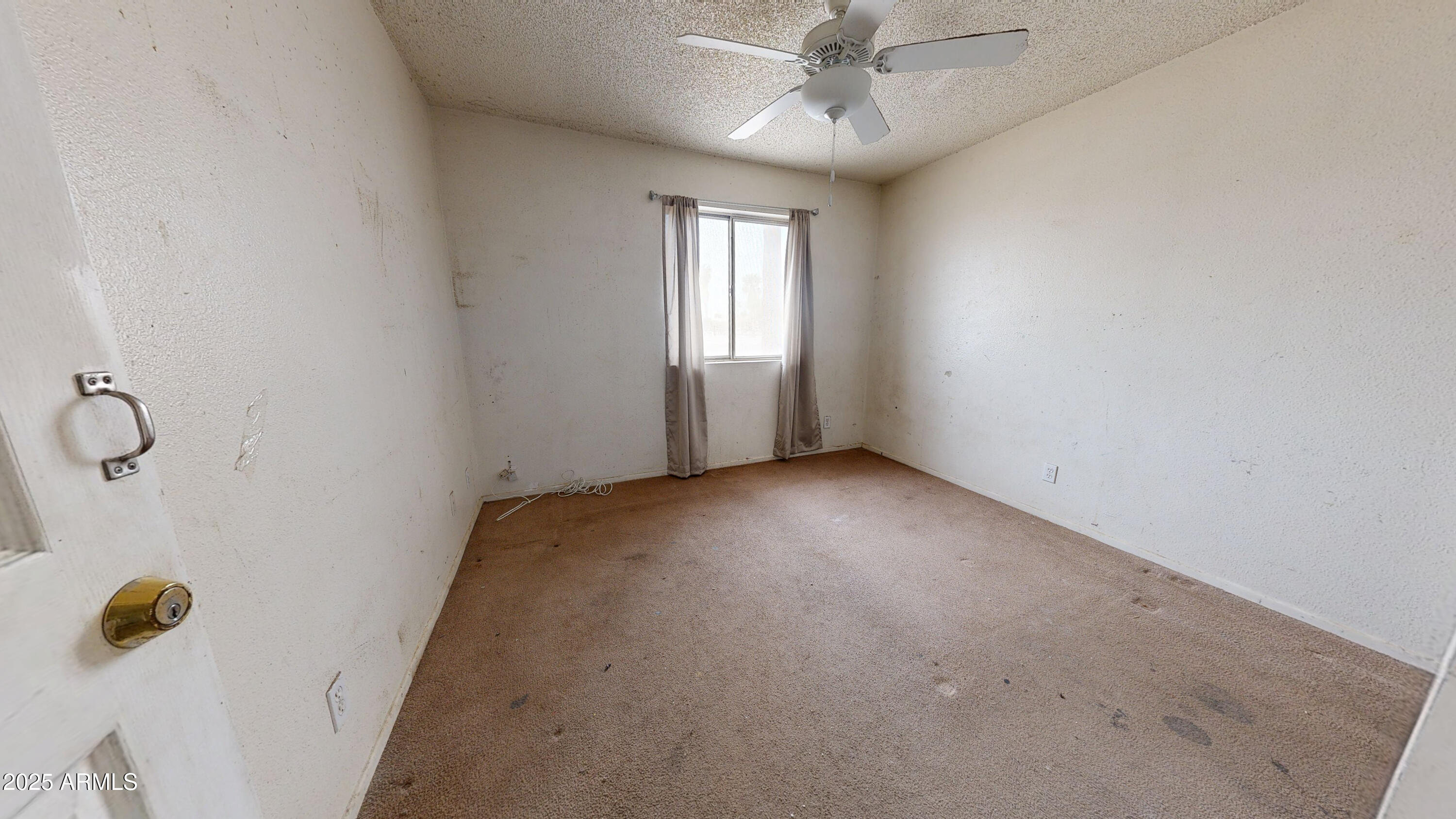 2351 South Royal Palm Road Apache Junction, AZ 85119 - Photo 10 of 21 an empty room with windows and fan