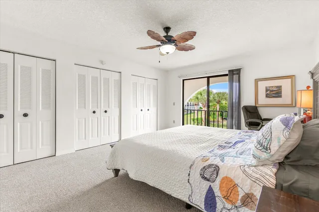 a spacious bedroom with a bed and a large window