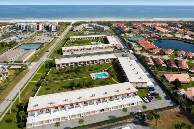 an aerial view of a house with swimming pool garden and patio