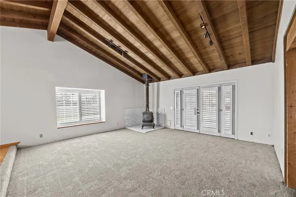 a view of an empty room with a fireplace