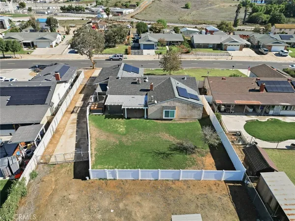 an aerial view of residential houses with outdoor space and parking