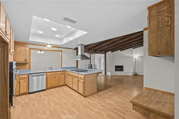 a large white kitchen with stainless steel appliances granite countertop a sink and cabinets