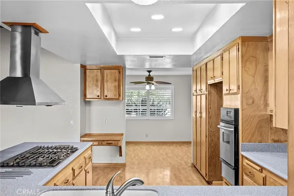 a kitchen with stainless steel appliances granite countertop a refrigerator and a stove top oven
