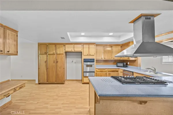 a kitchen with stainless steel appliances granite countertop a sink and a stove