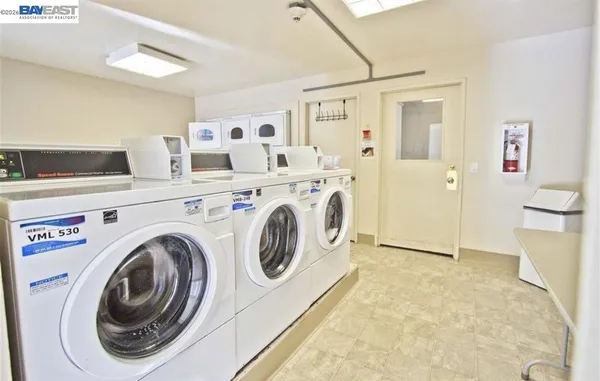 a view of washer and dryer with kitchen in the background