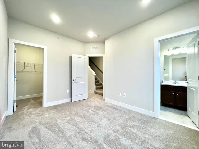 an empty room with windows and closet