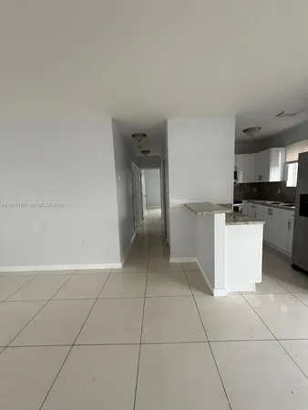 a view of a kitchen with cabinets and stainless steel appliances