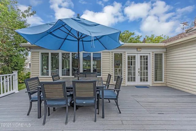 a view of a patio with a table and chairs under an umbrella