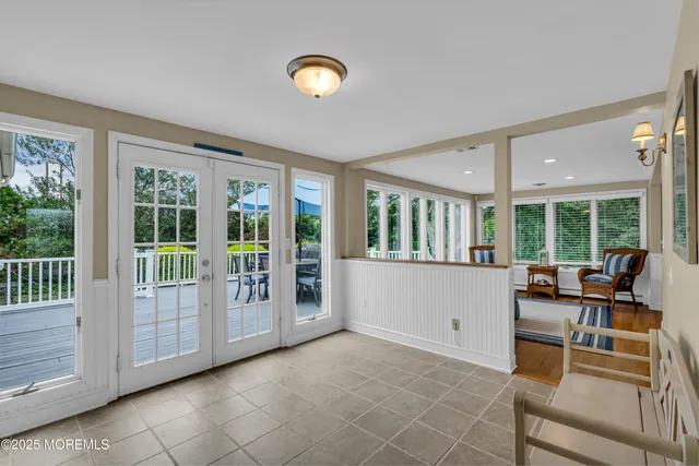 a living room with furniture and large windows