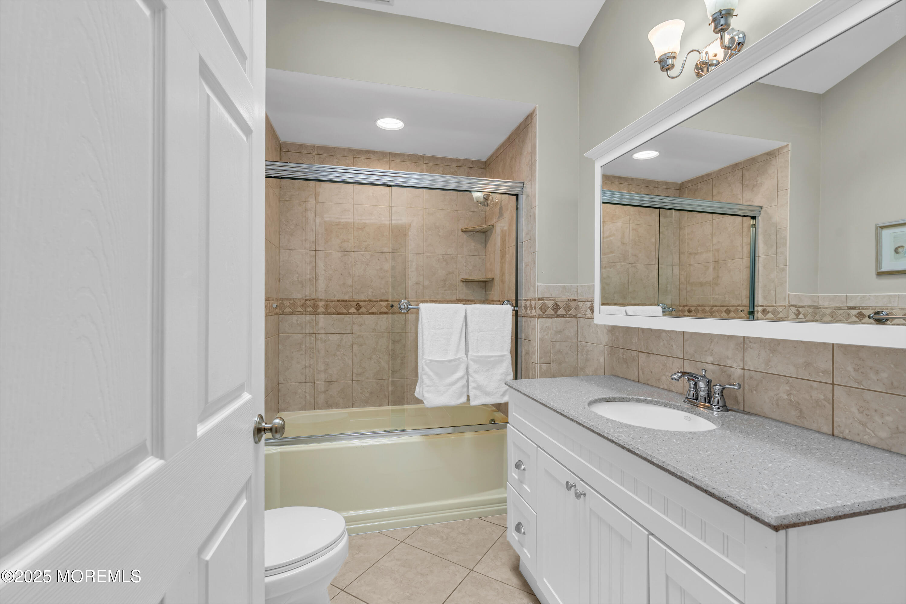 218 3rd Avenue Belmar, NJ 07719 - Photo 8 of 14 a bathroom with a granite countertop sink a mirror a toilet and bathtub