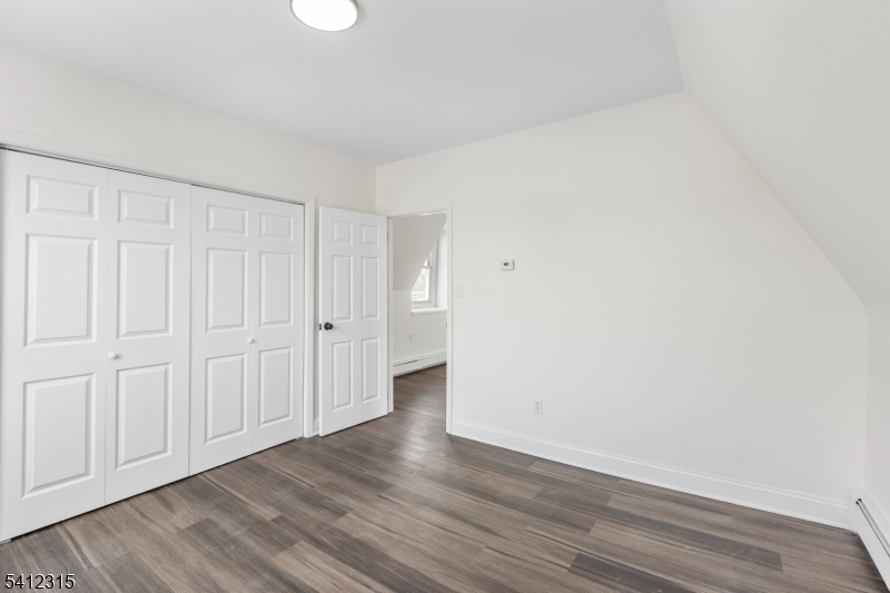 676 Chestnut Street, Unit 3 Kearny, NJ 07032 - Photo 14 of 21 a view of an empty room and wooden floor